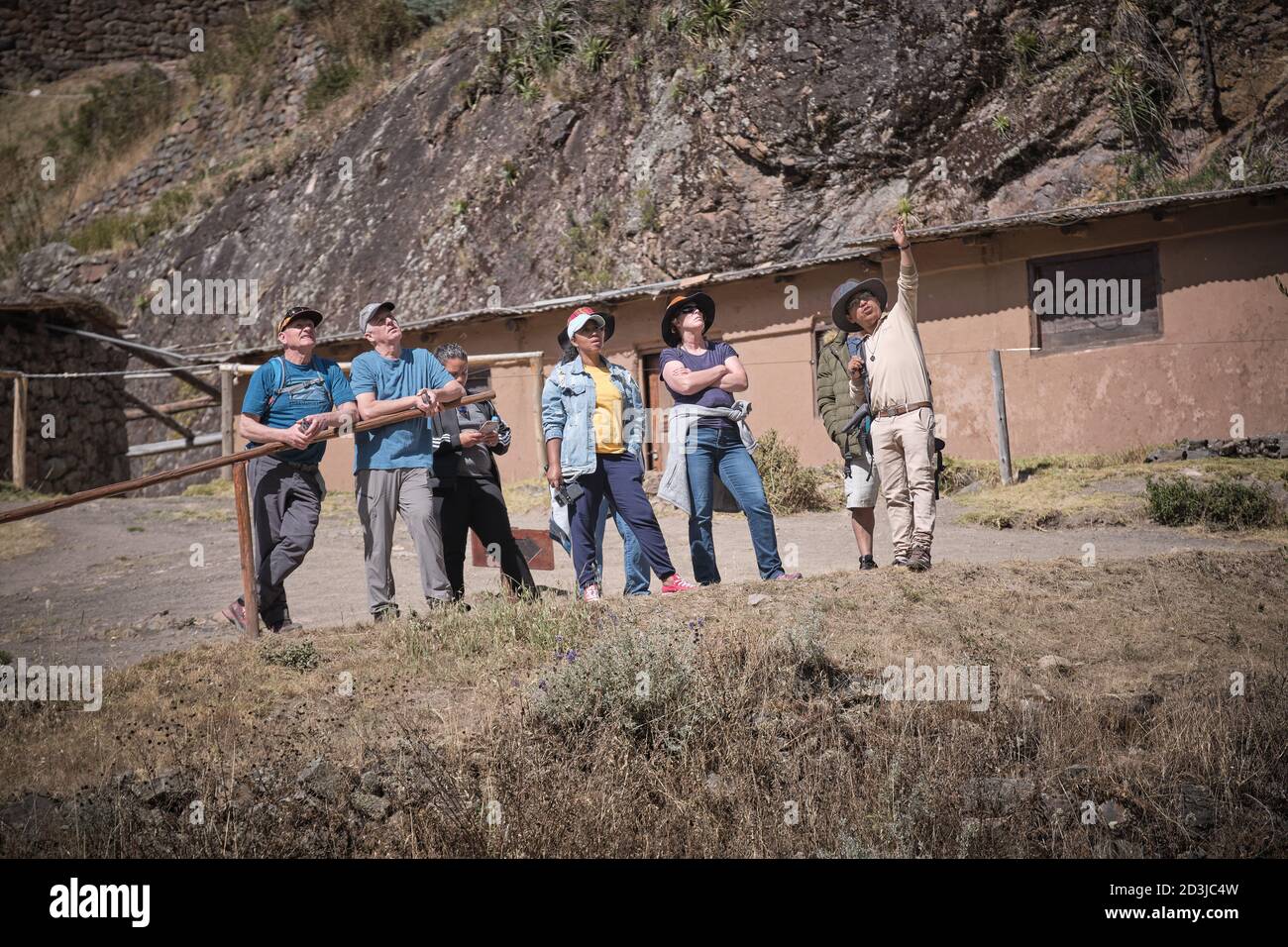 A guide showing tourists around Pisaq Pisac Incan site, Peru Stock Photo