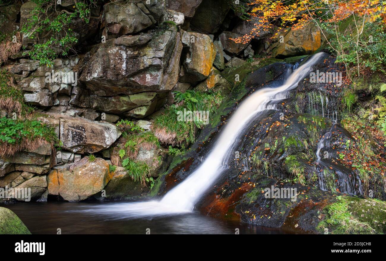 An idyllic scene of shattered rocks, falling water and autumnal colours, Upper Posforth Gill waterfall, Valley of Desolation, Wharfedale, Yorkshire Stock Photo