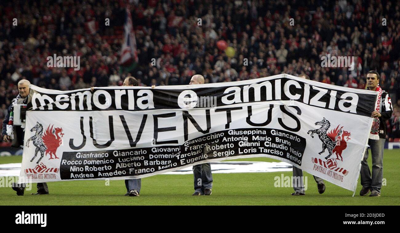 Liverpool and Juventus fans carry a banner stating the name of those killed  in the Heysel Stadium disaster before their Champions League match at  Anfield. Liverpool and Juventus fans carry a banner