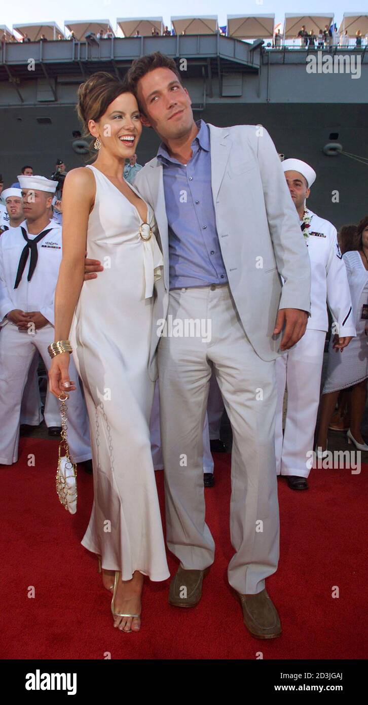 Ben Affleck and British actress Kate Beckinsale, lead actors in action drama film "Pearl Harbor" pose together in at Pearl with the aircraft carrier USS John C. background