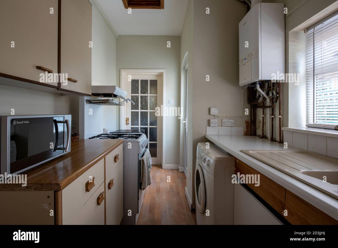 Galley kitchen in terraced house, in need of refurbishment, West