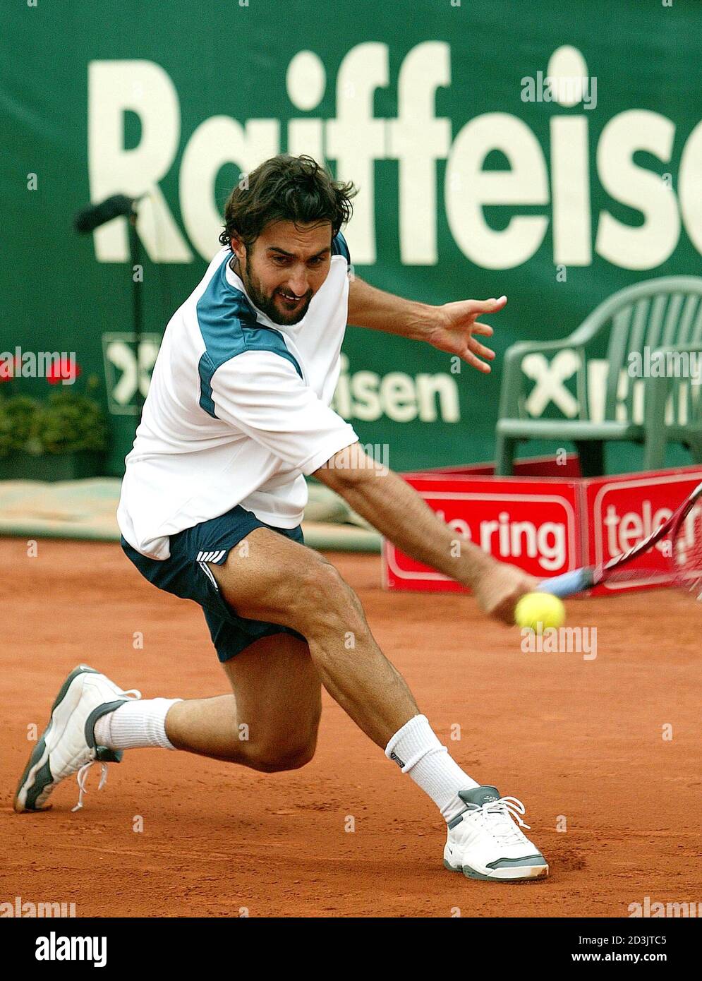 Nenad Zimonjic of Serbia and Montenegro returns a ball to Andre Agassi of  the United States during their ATP Grand Prix match in St. Poelten, Austria  May 17, 2004. Zimonjic won 6-2