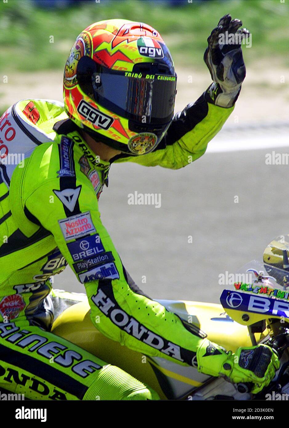 Italian 500cc rider Valentino Rossi rides waving after setting the third  position at the Estoril Grand Prix September 3, 2000. Valentino Rossi set  the third place in a time of 48 minutes