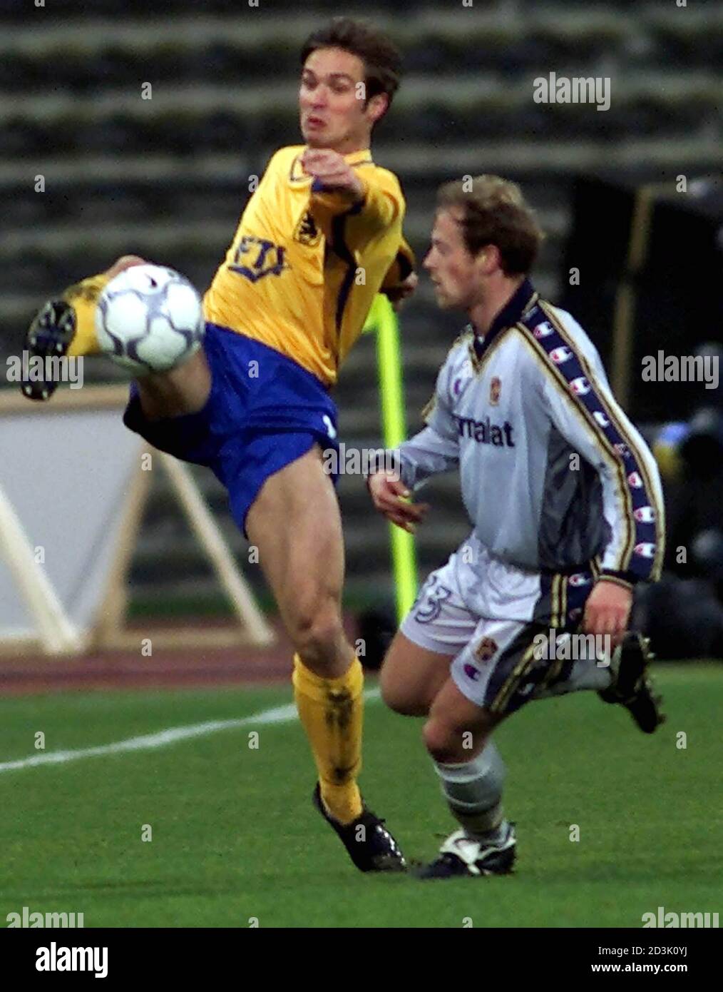 Harald Cerny (L) of TSV 1860 Munich challenges Gianluca Falsini of AC Parma during their third round, second leg UEFA Cup soccer match in Munich's Olympic stadium, December 5, 2000.  MAD Stock Photo