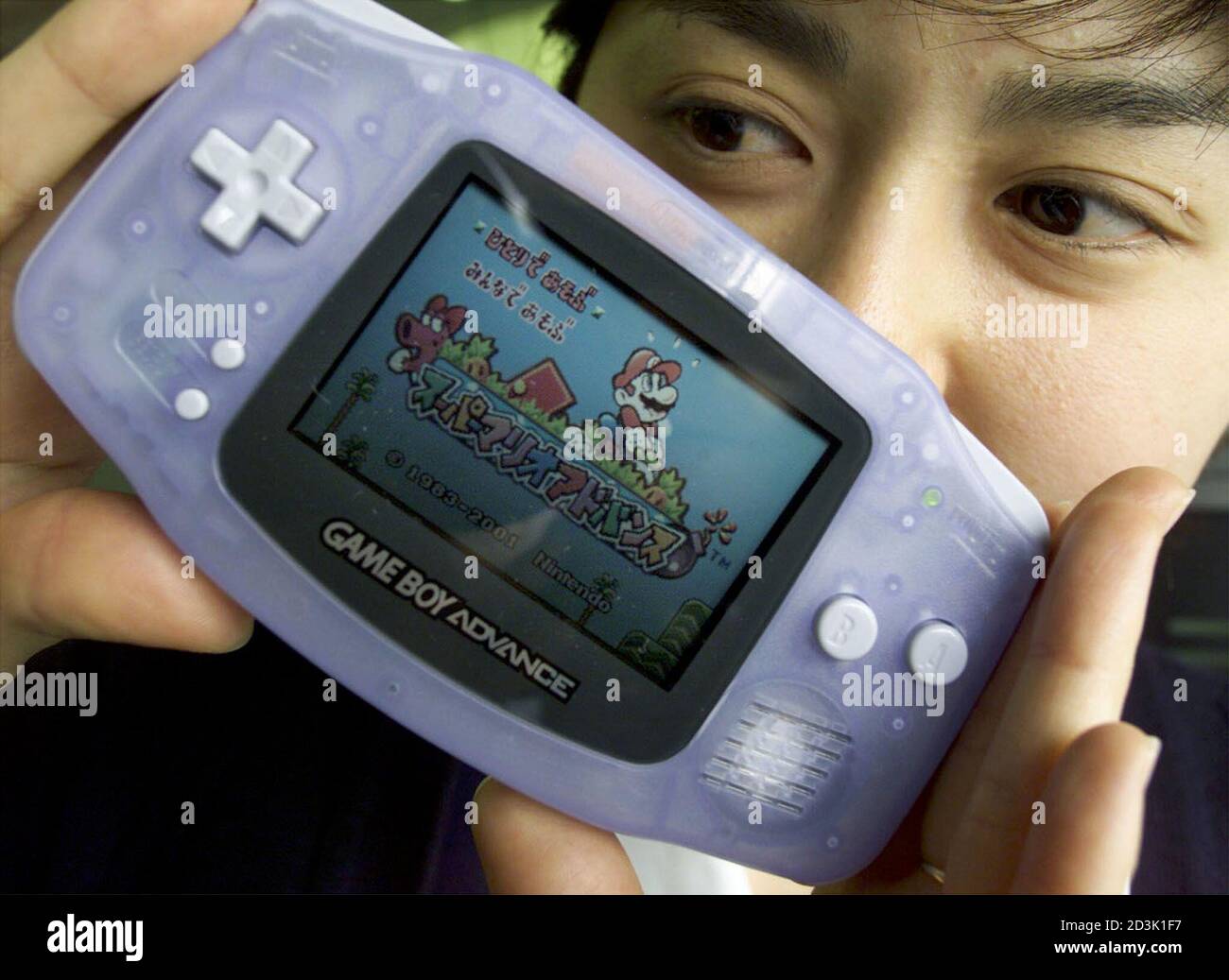 Promoter Tomoyo Tohei shows off the Nintendo's next-generation hand-held  console Game Boy Advance in Tokyo March 21, 2001, the successor to the  company's bestselling Game Boy machine. The faster Game Boy Advance,