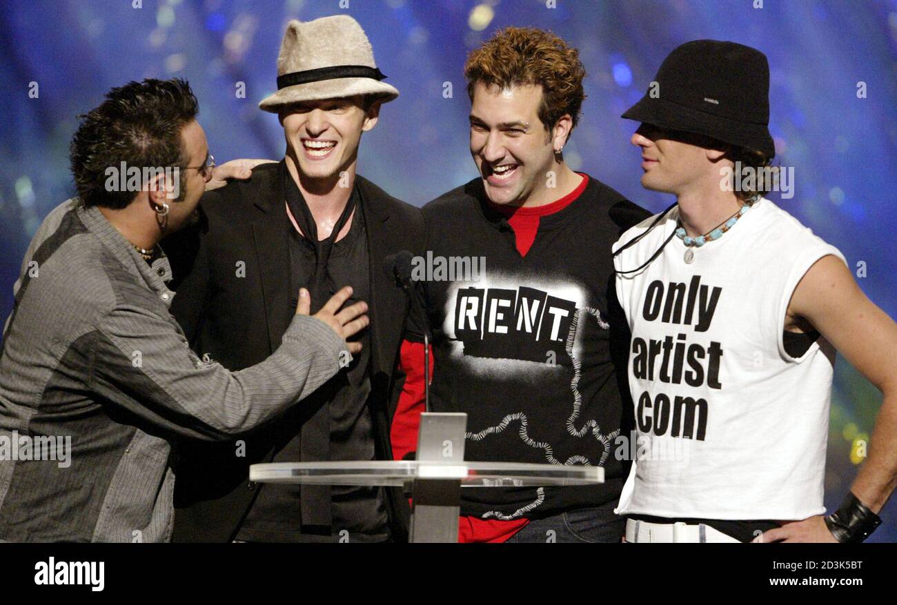 Justin Timberlake (second from left) is greeted by his bandmates from 'NSYNC after his first live solo performance at the 2002 MTV Video Music Awards at Radio City Music Hall in New York on August 29, 2002. Stock Photo
