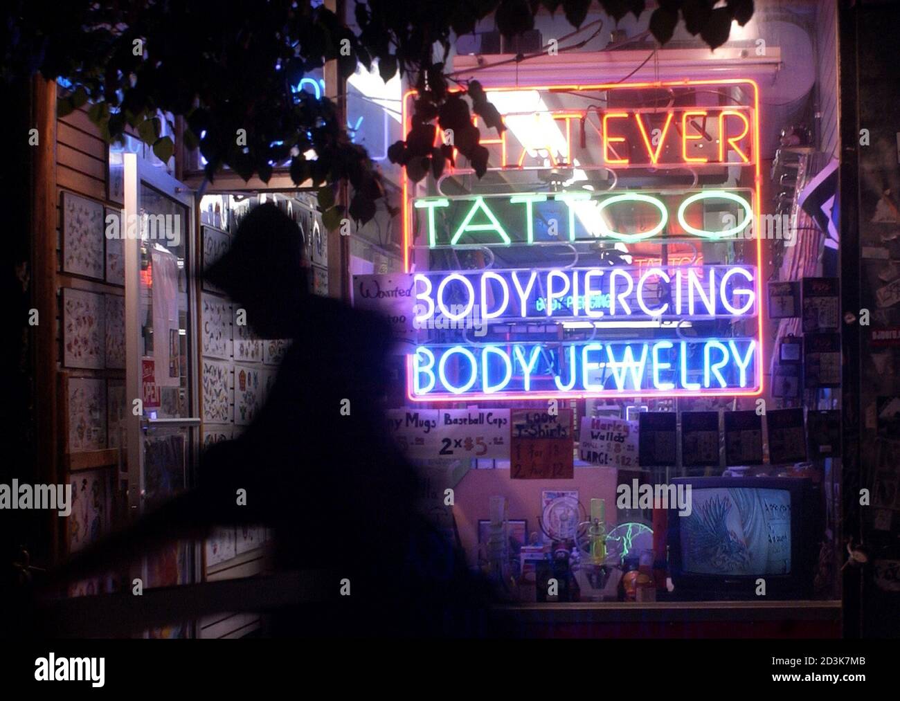 View of a tattoo and piercing shop in New York, May 27, 2003. The latest trend among teens and twentysomethings who indulge in so-called extreme body modification, forking one's tongue like a serpent's 'is an art form,' said T.J. McGillis, who offers the service for a $250 charge. REUTERS/Chip East REUTERS PP03060055  CME Stock Photo