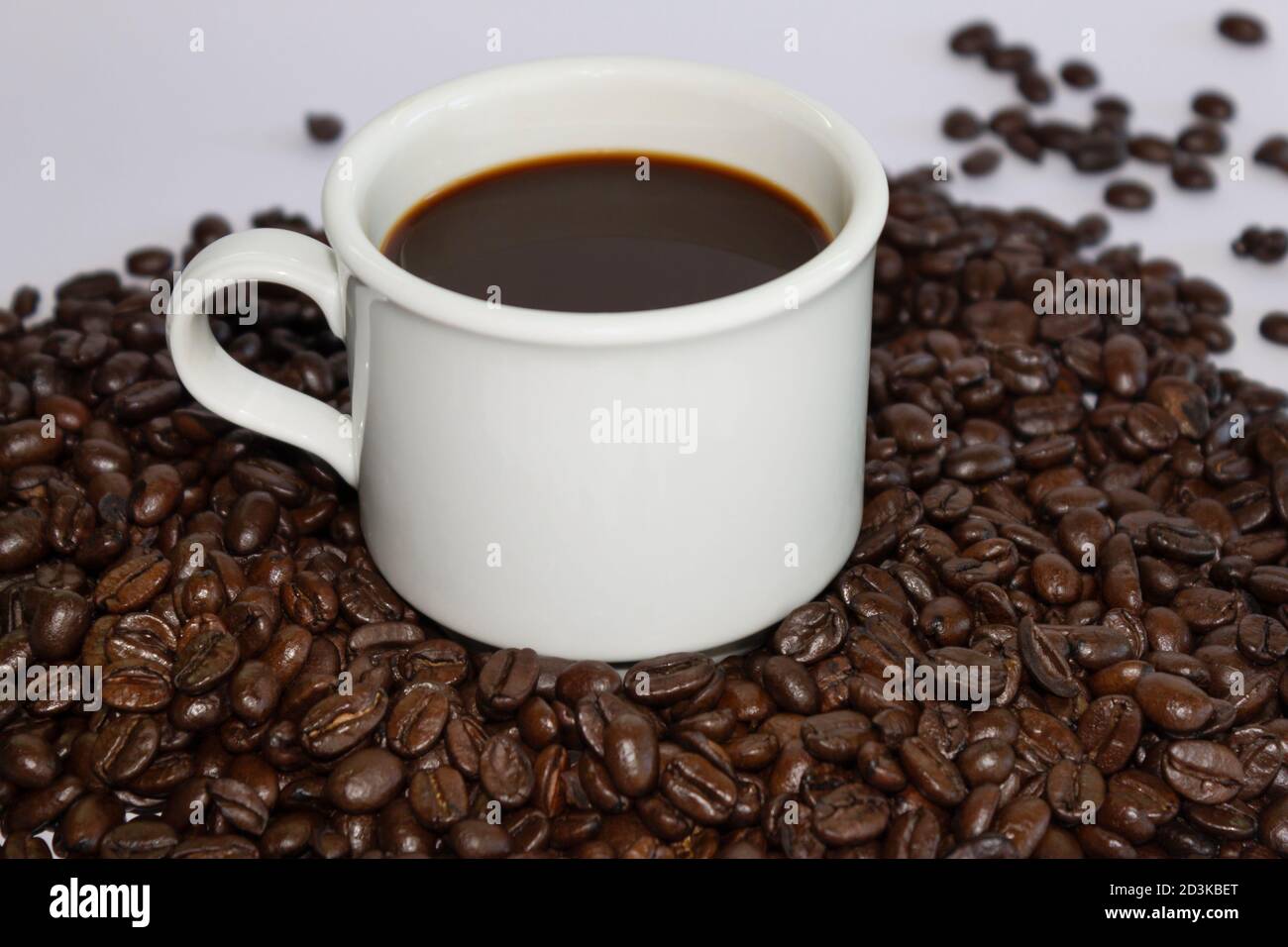 Coffee cup and coffee beans on white background Stock Photo - Alamy