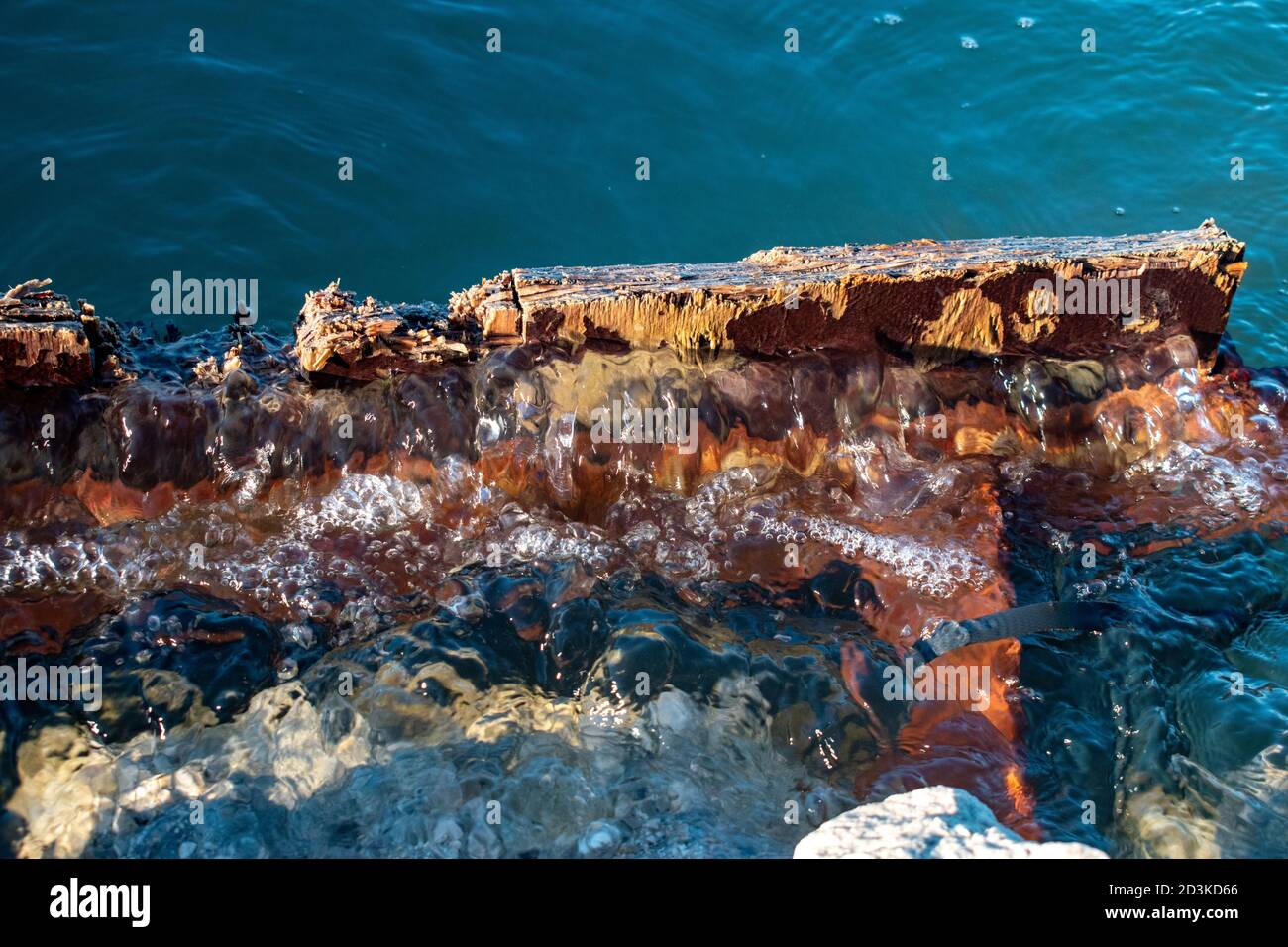 Crystal blue water rising from a submerged piece of wood Stock Photo ...