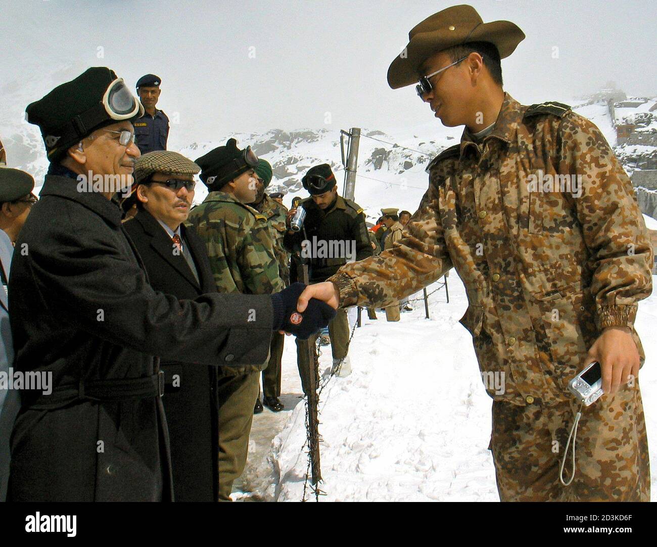India's Home Minister Patil shakes hands with Chinese army officer during visit to Indo-China border at Nathula in India's Sikkim state.  India's Home Minister Shivraj Patil (L) shakes hands with a Chinese army officer during his visit to the Indo-China border in Nathula in Sikkim state, 175 km (109 miles) from the northeastern Indian city of Siliguri April 4, 2005. A longstanding boundary dispute between China and India will be on the agenda when Chinese Premier Wen Jiabao visits New Delhi this week. REUTERS/Rupak De Chowdhuri Stock Photo