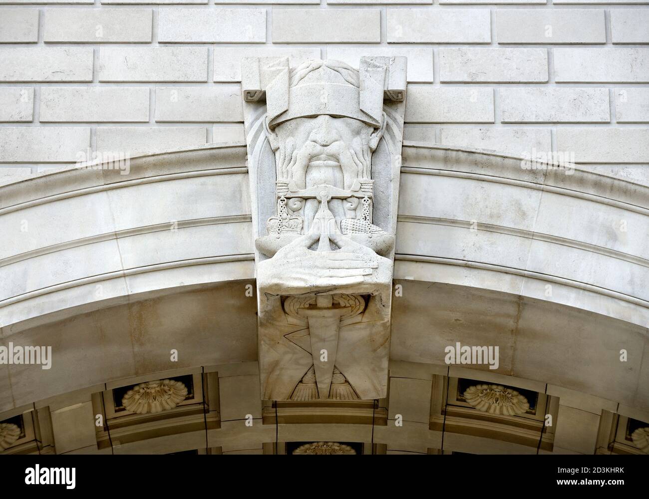 London, England, UK. Thames House,  2 Millbank (1930. HQ of MI5 since 1994) Decorative keystone and arch. Blindfolded man with a sword and scales... Stock Photo