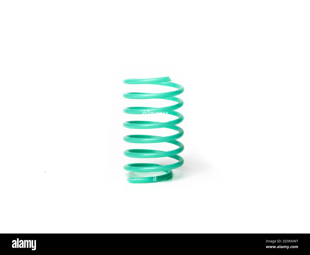 Small plastic spring. Can be used as cat toy. Concept for catch and grab play with kitten to improve natural hunting skills. Isolated on white. Stock Photo