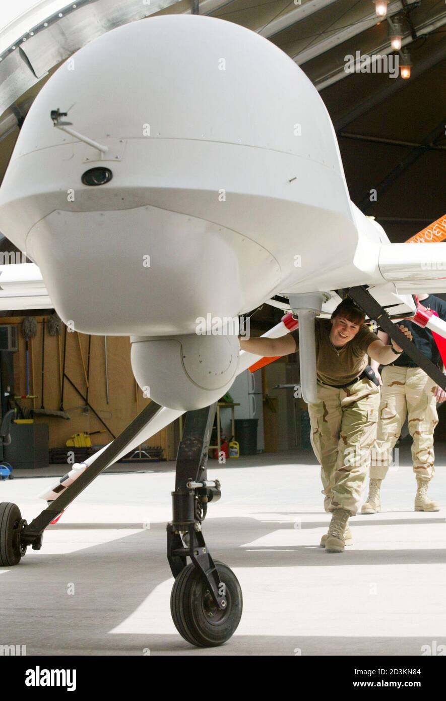 A United States Air Force technician pushes a Predator unmanned surveillance plane out of its hangar at an airbase in the Gulf March 10, 2003. France waged a diplomatic battle against the United States and Britain on Monday to woo wavering nations into the anti-war camp for a U.N. vote unlikely to alter U.S. plans to invade Iraq. REUTERS/Chris Helgren  CLH/ Stock Photo