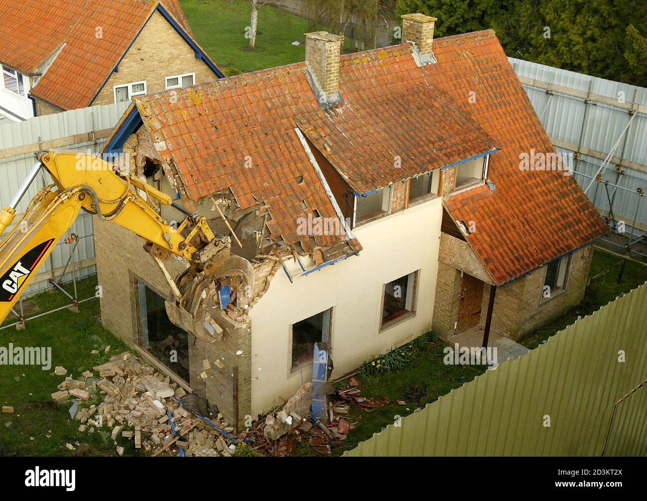 The house where British murderer Ian Huntley who killed 10-year-old Soham school girls Holly Wells and Jessica Chapman is demolished in Soham, Cambridgeshire, eastern England, April 3, 2004. Cambridgeshire council condemned the property fearing it would be a permanent reminder of the grisly deaths, which have haunted the local community. Huntley murdered the girls in August 2002 after luring them into the house that came with his job as caretaker at Soham Village College, which was on the same site as their primary school. REUTERS/Peter Macdiarmid  PKM/JD Stock Photo