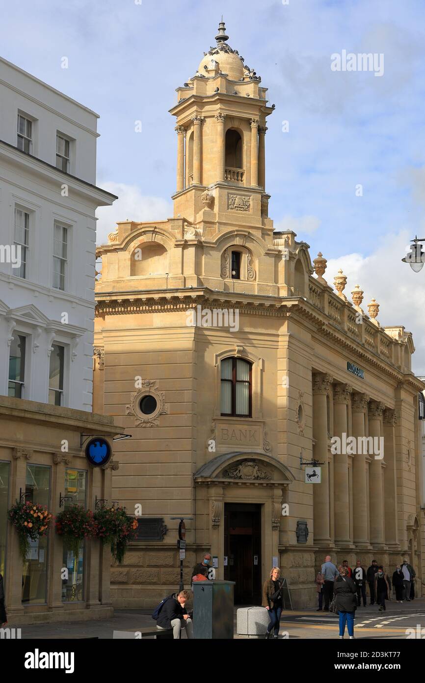 Lloyds Bank Cheltenham High Street with people queueing to enter during global Coronavirus pandemic. Stock Photo