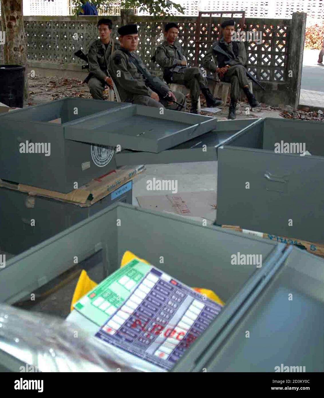 Thai soldiers sit next to ballot boxes ahead of elections in Yala province, 1,200 km (750 miles) south of Bangkok, on February 5, 2005. The national election is scheduled for Sunday. REUTERS/Surapan Boonthanom  SS/SA/LA Stock Photo