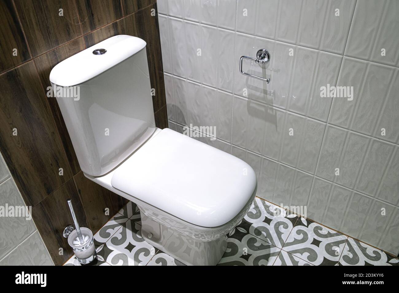 Modern toilet bowl with a tank is closed with a lid. Near capacity for