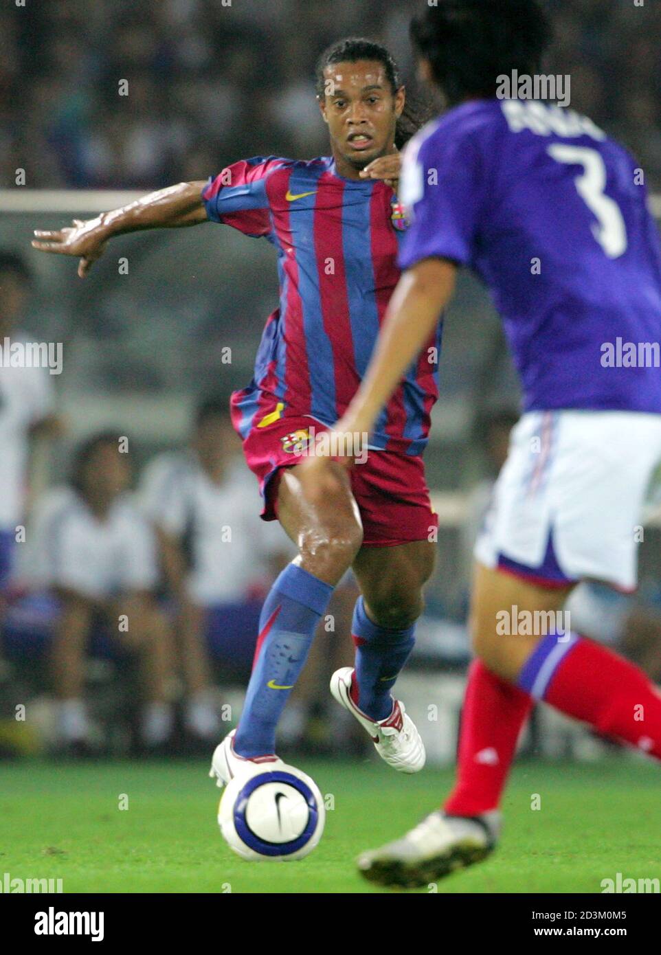Spanish Club Fc Barcelona S Ronaldinho Dribbles The Ball Against Japan S J League Club Yokohama Marinos Naoki Matsuda During The An Exhibition Match At Nissan Stadium In Yokohama South Of Tokyo July 30 05