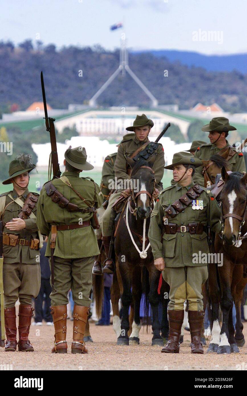 Australian war veterans, dressed in traditional Australian Lighthorse  uniforms, prepare to march during the Anzac Day (Australian and New Zealand  Army Corps) memorial service in front of the Parliament House (rear) in