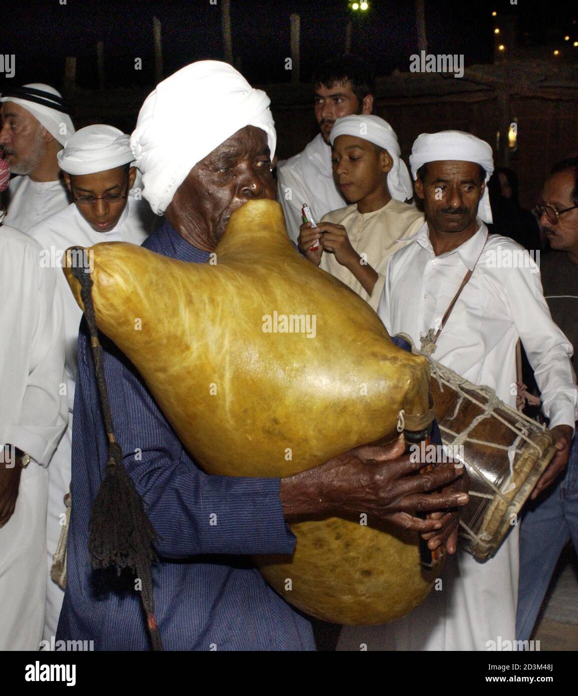 Ibrahim Guloom a member of a traditional musical troupe plays an old piper  instrument made out of goat skin during the Eid Al Fitr celebrations  December 18, 2001. United Arab Emirates celebrate