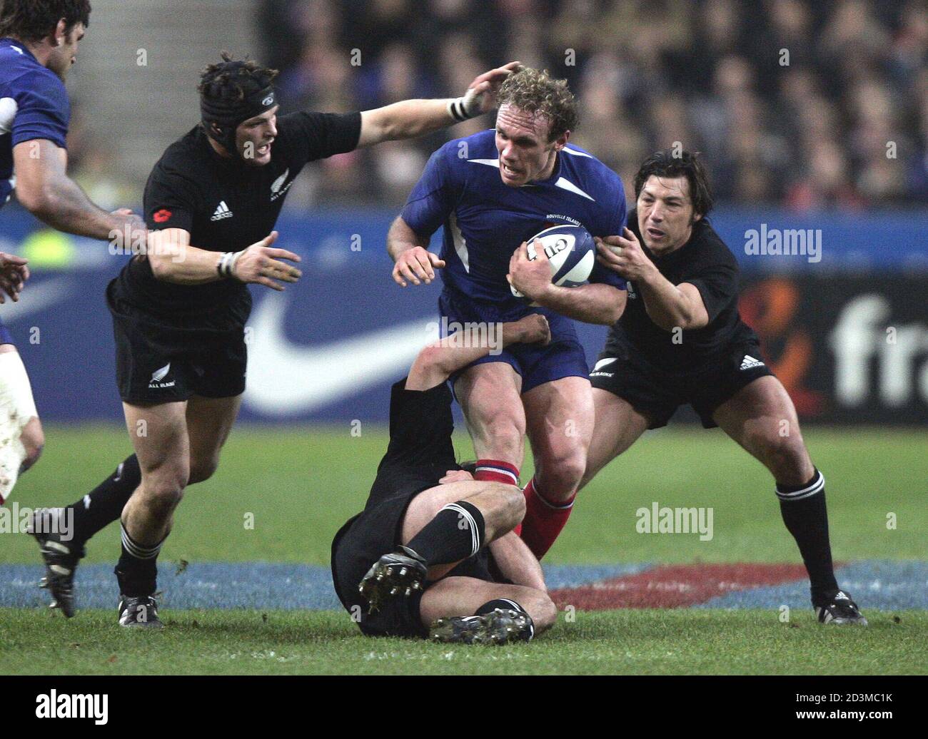 Liebenberg of France is tackled by All Blacks Kelleher and McCaw during  their rugby test match at the Saint-Denis Stade de France. Brian Liebenberg  of France (C) is tackled by All Blacks