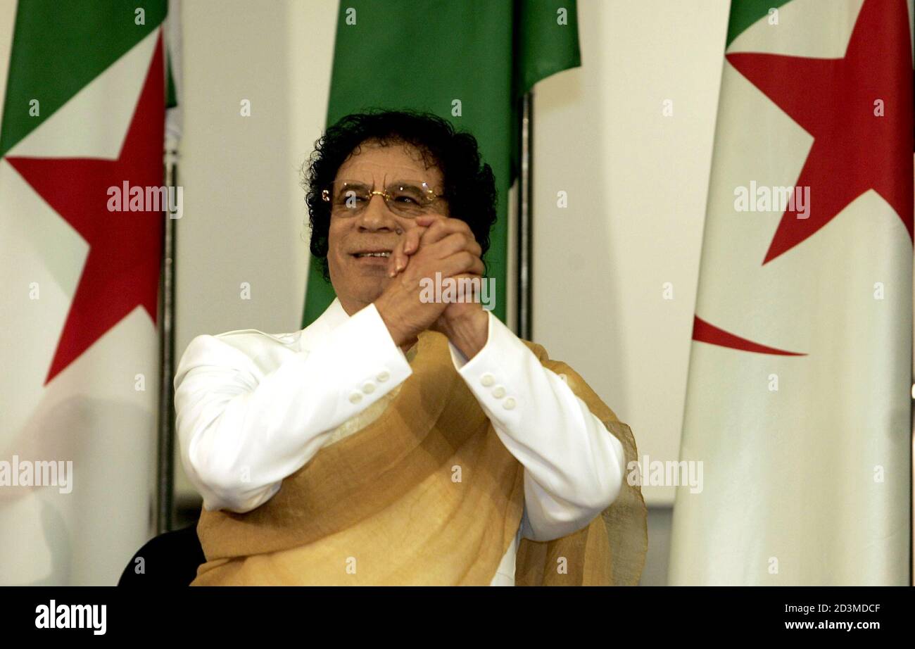 Libyan Leader Muammar Gaddafi Gestures As He Greets The Audience At The Nations Palace In Algiers March 27 2005 The Libyan Leader Who Came To The Algerian Capital To Attend The Arab Countries