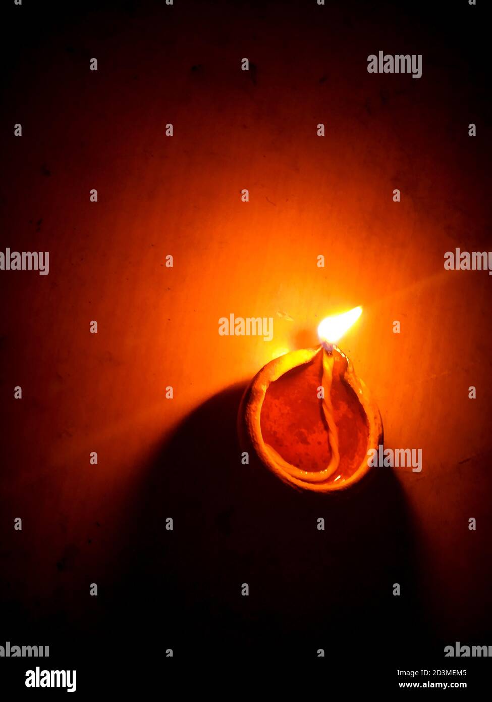 Colorful clay diya lamps lit during diwali celebration.Close up of heap of Indian clay oil lanterns or diyas for Diwali festival celebration at local . Stock Photo