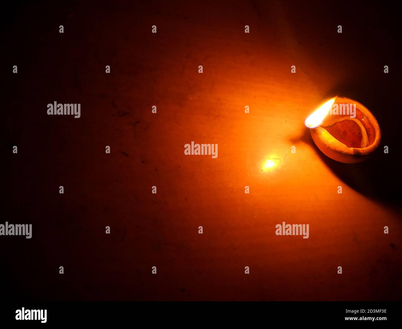 Colorful clay diya lamps lit during diwali celebration.Close up of heap of Indian clay oil lanterns or diyas for Diwali festival celebration at local . Stock Photo