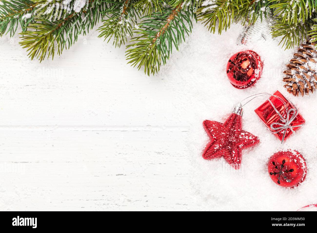 Christmas greeting card with fir tree and decor over white wooden ...