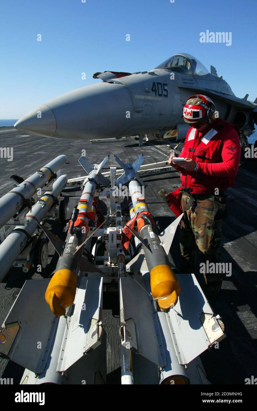 ORDNANCE WORKER JOTS DOWN SERIAL NUMBERS OF AIM-9 SIDEWINDER MISSILES ON BOARD THE USS ABRAHAM LINCOLN IN THE GULF. Stock Photo