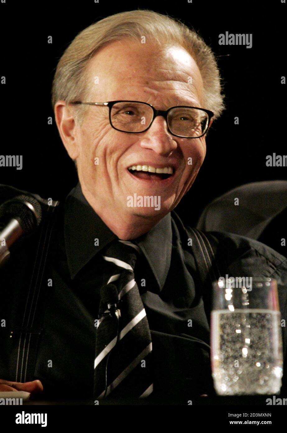 CNN talk-show host Larry King laughs as he moderates a roundtable discussion with gaming industry leaders during the Global Gaming Expo in Las Vegas, Nevada, October 6, 2004. Stock Photo