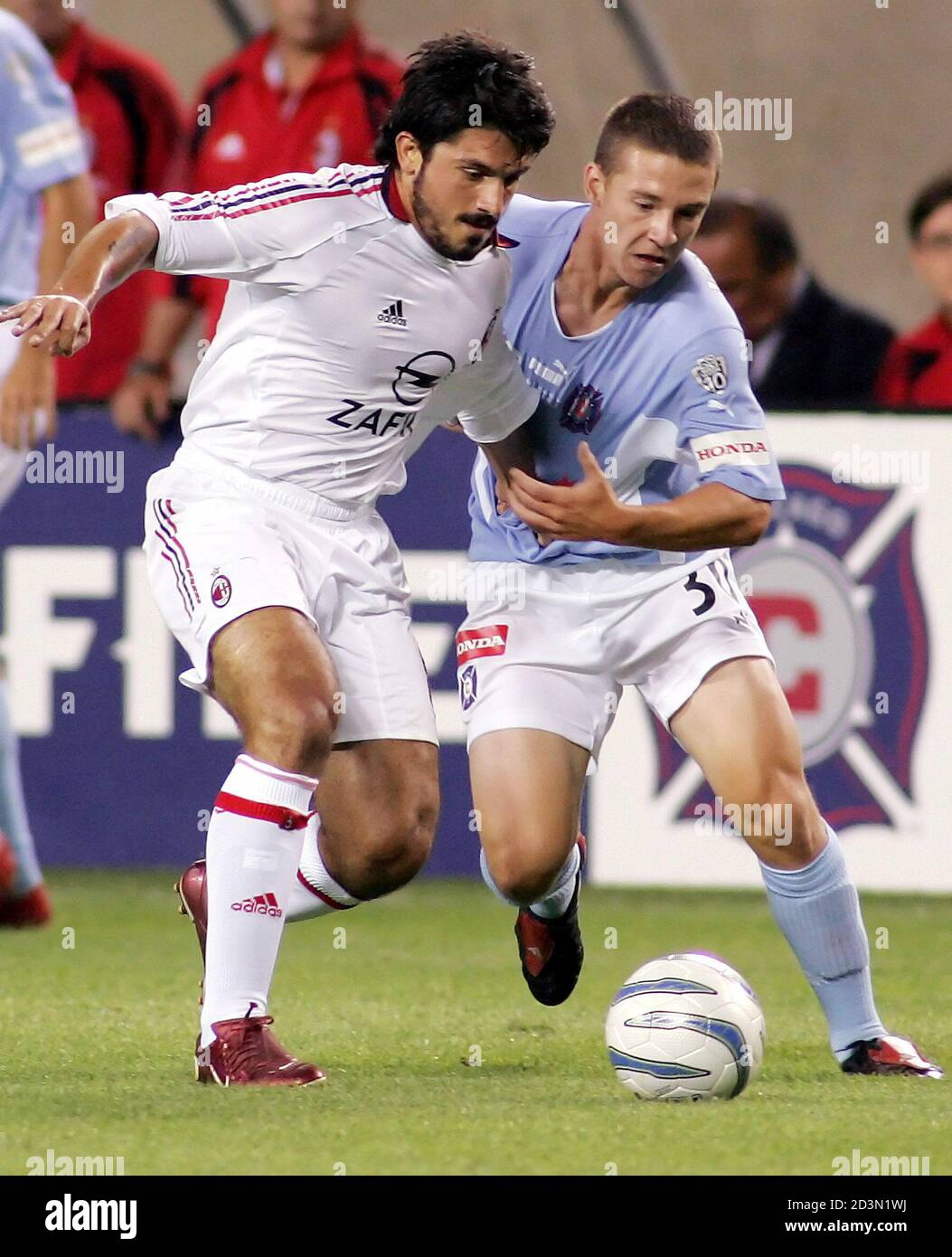 Ac Milan Midfielder Gennaro Gattuso L Fights For The Ball With Chicago Fire Forward Will Johnson In Chicago Ac Milan Midfielder Gennaro Gattuso L Fights For The Ball With Chicago Fire Forward