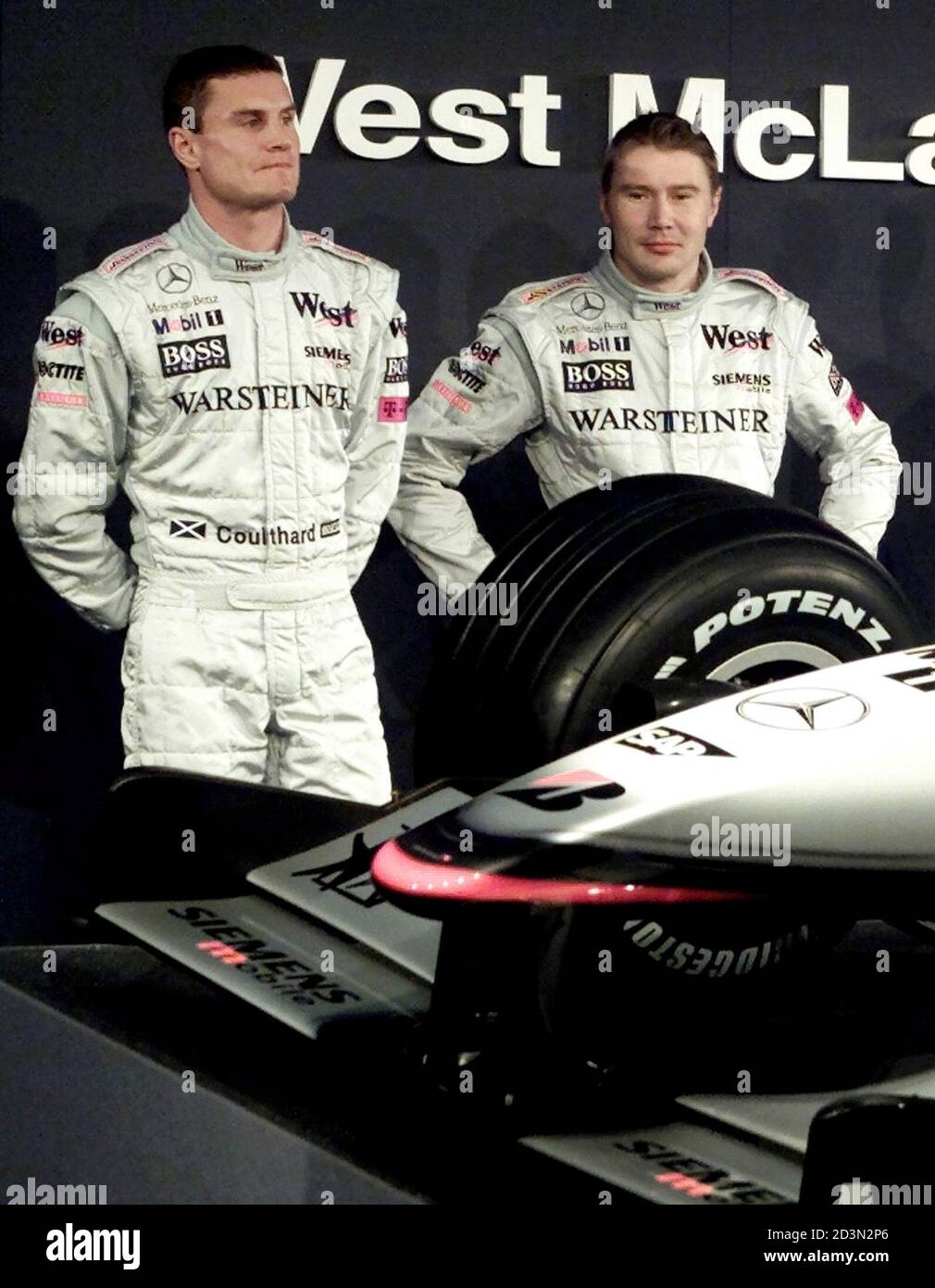West McLaren Mercedes drivers David Coulthard of Britain (L) and Mika  Hakkinen of Finland pose next to the new MP4-16 car during their team  presentation in Valencia February 7, 2001. Hakkinen, runner-up
