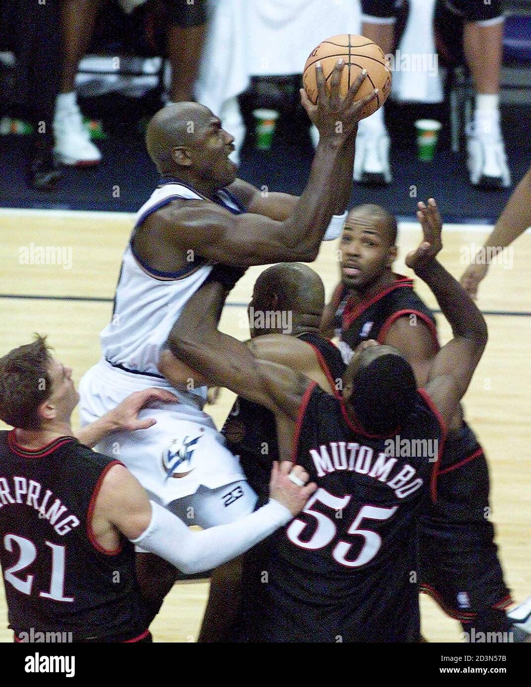 Wizards' Michael Jordan a crowd of Philadelphia 76ers as he goes up for a shot in the fourth at the MCI Center in Washington November 3, 2001. players,