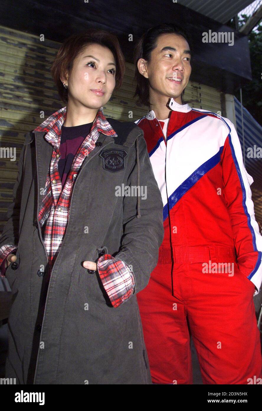 Hong Kong singer-actress Sammi Cheng (L) and Taiwanese singer-actor Richie Yum pose for photographers before shooting the romance film 'Marry a Rich Man' in Hong Kong December 18, 2001. The movie is due for release in January 2002. REUTERS/Kin Cheung  KC/RCS Stock Photo