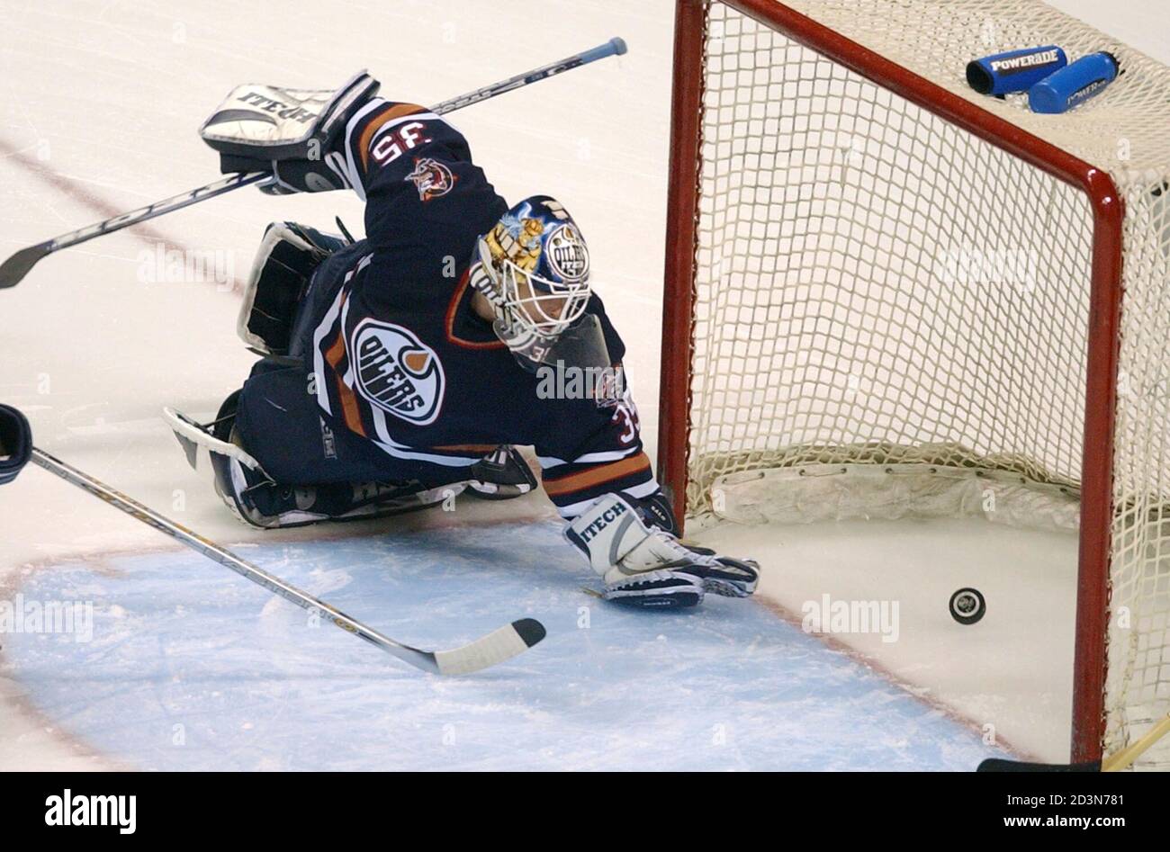Edmonton Oilers Goalie Tommy Salo Watches A Puck Go By Off A Shot By The San