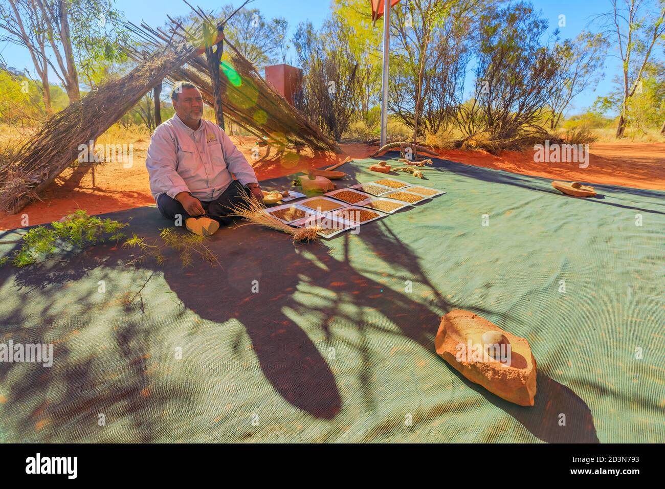 Kings Creek Station, Northern Territory, Australia - Aug 21, 2019: Australian Aboriginal guide shows bush seeds, food, and medical plants, during the Stock Photo