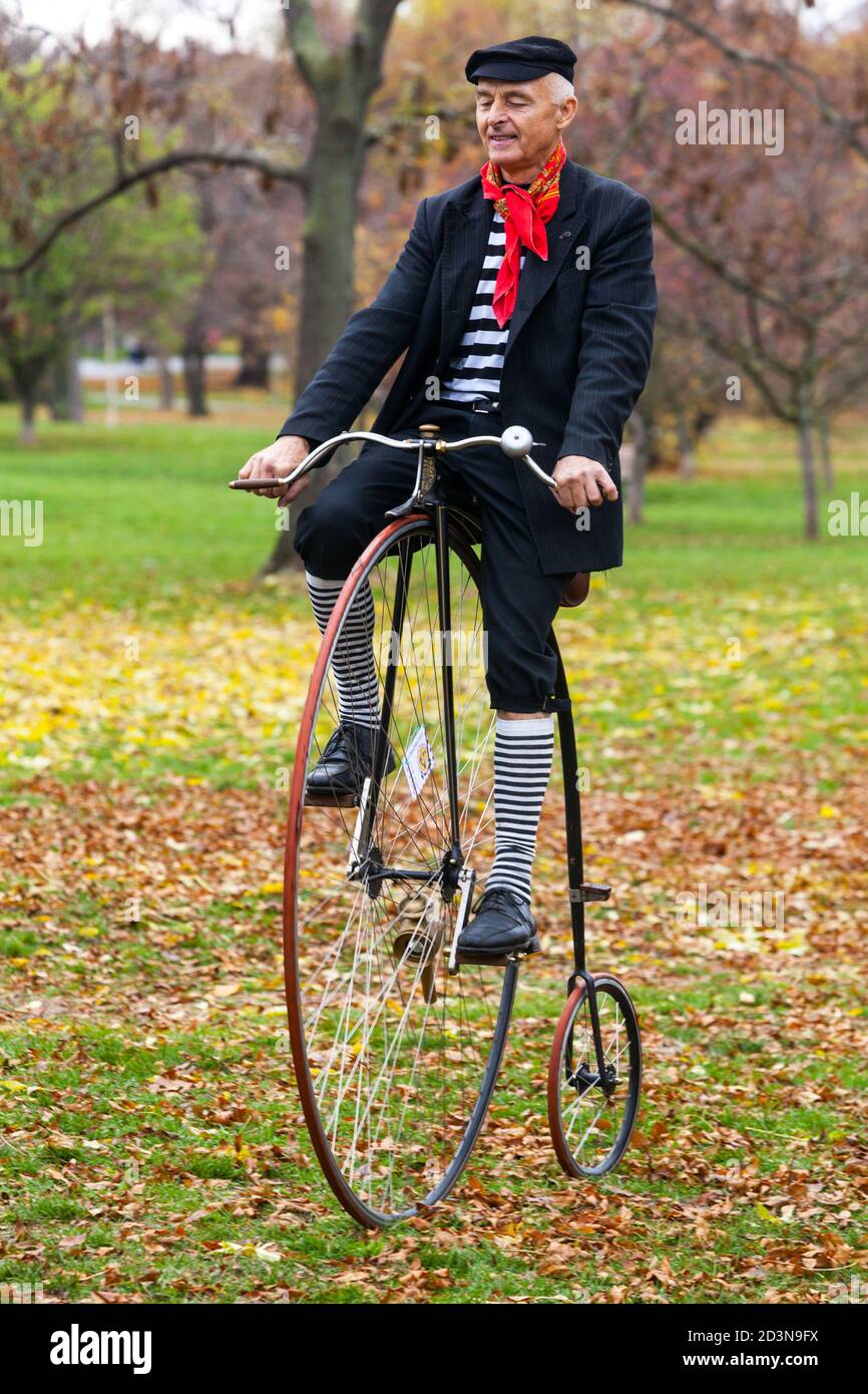 Man on Penny Farthing bicycle vintage Stock Photo