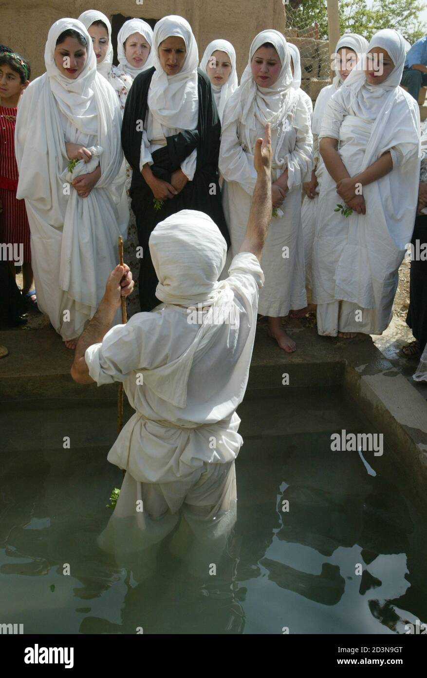 Five Iraqi Mandean brides prepare to be baptised in water from the Tigris river by a priest speaking the ancient Aramaic language during a wedding ceremony in Baghdad June 8, 2003. Iraqi devotees of an obscure religion who take John the Baptist as their central figure perform virginity tests on their brides and take a dip in the murky Tigris river every Sunday to purify the soul. Most of the worldAEs 20,000 or so Mandeans live in southern Iraq and southwestern Iran. REUTERS/Faleh Kheiber  CLH/ Stock Photo