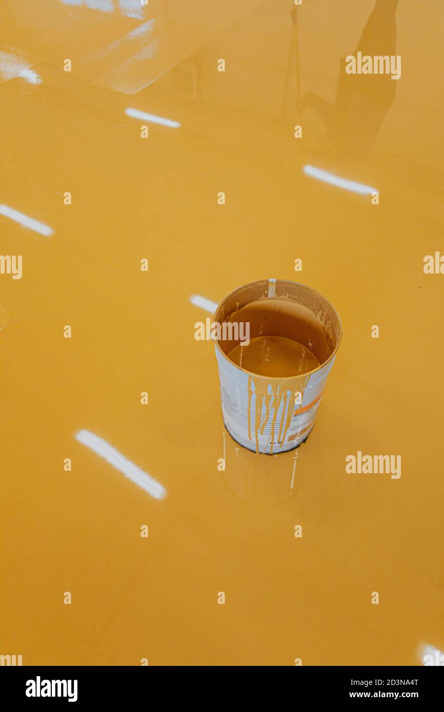 Industrial hall with colored floor, bucket.Epoxy resin applied to the