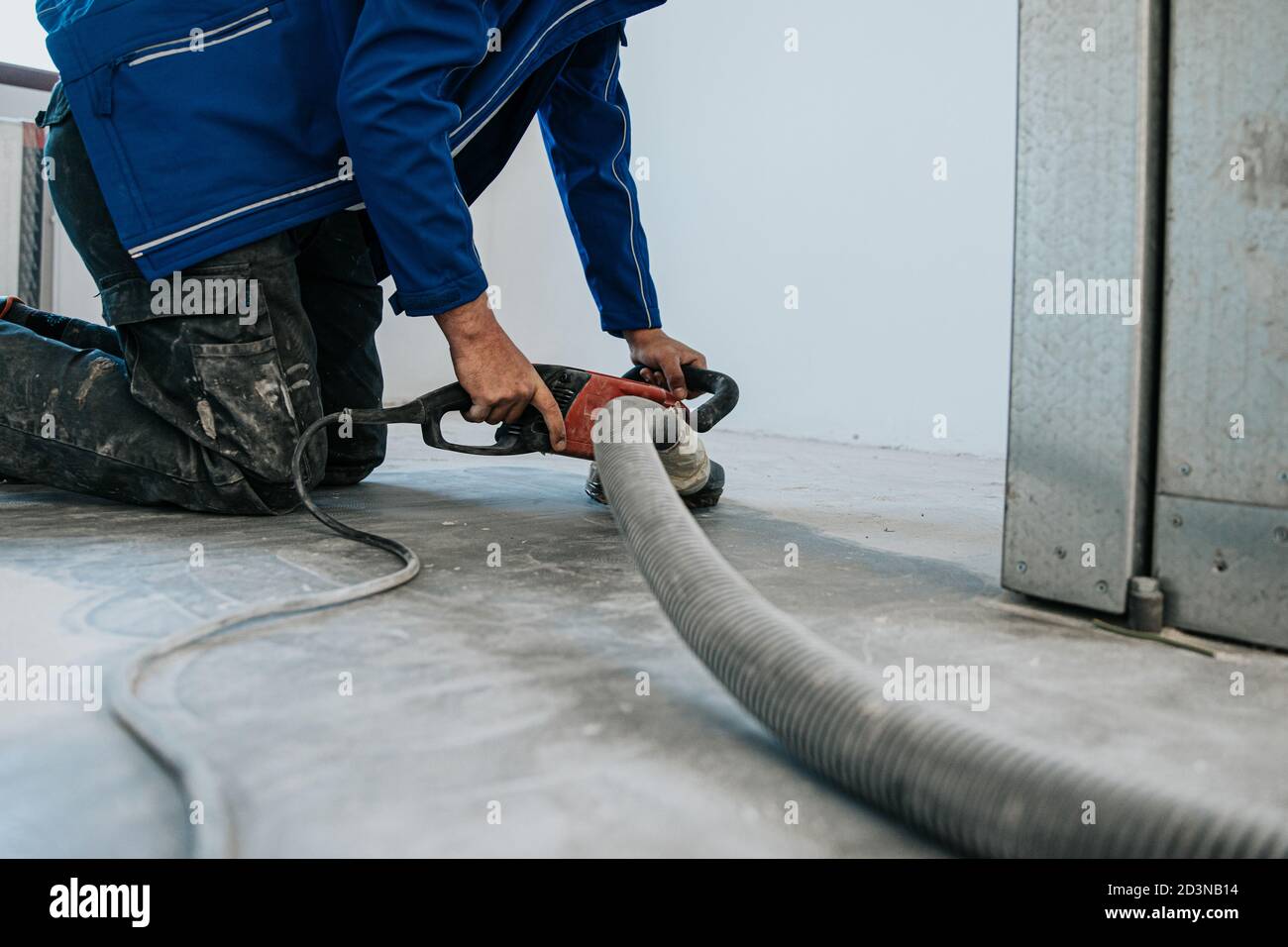 Construction worker using machine polishing surface floor smoothing and ...