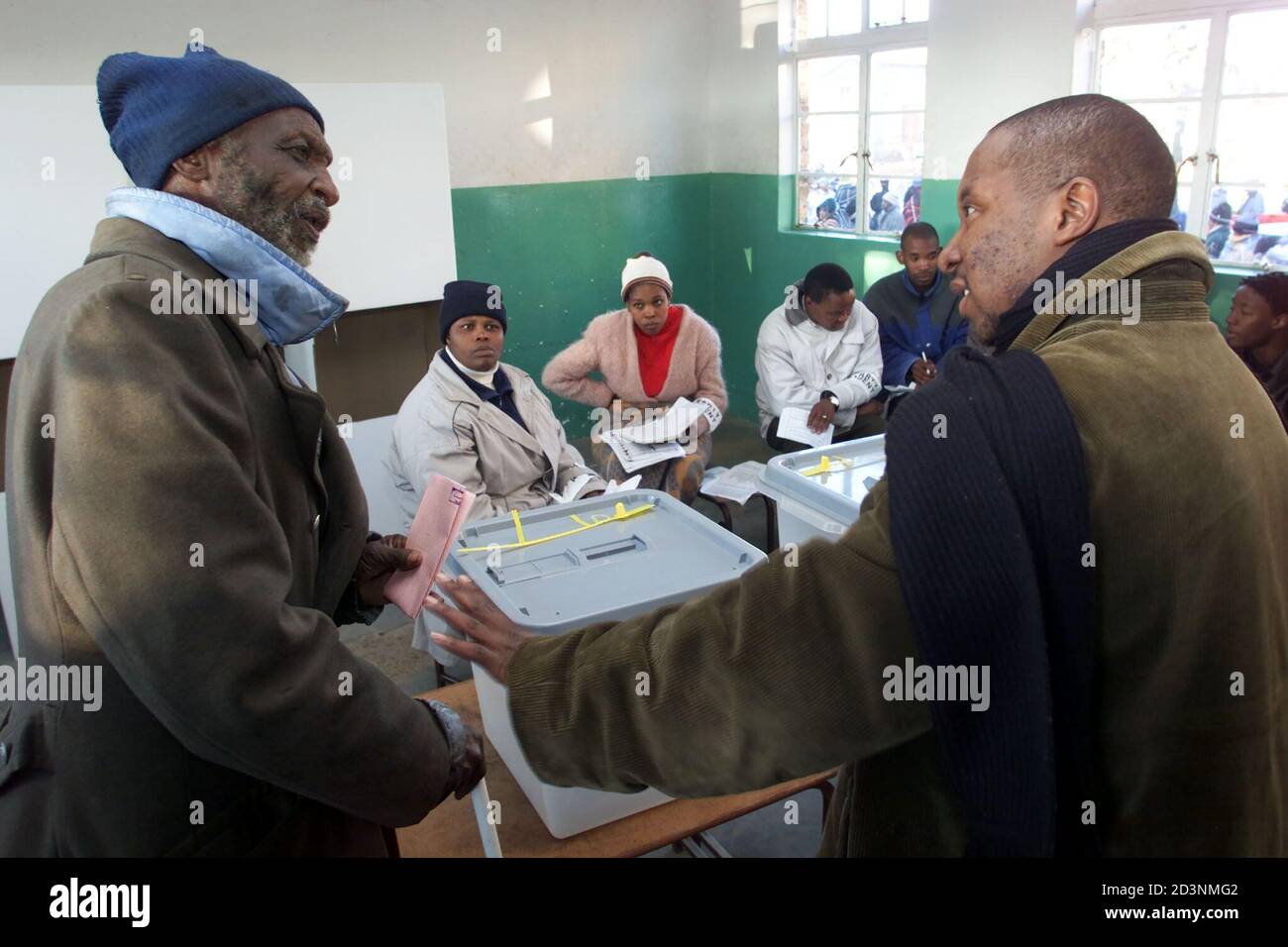 An election officer explains new dual voting procedures to a confused voter as Lesotho's general election gets underway May 25, 2002. The tiny southern African mountain kingdom is holding it's first election under a new electoral system with 19 political parties competing for 80 constituency and 40 proportional representation seats. REUTERS/Mike Hutchings  MH/ Stock Photo