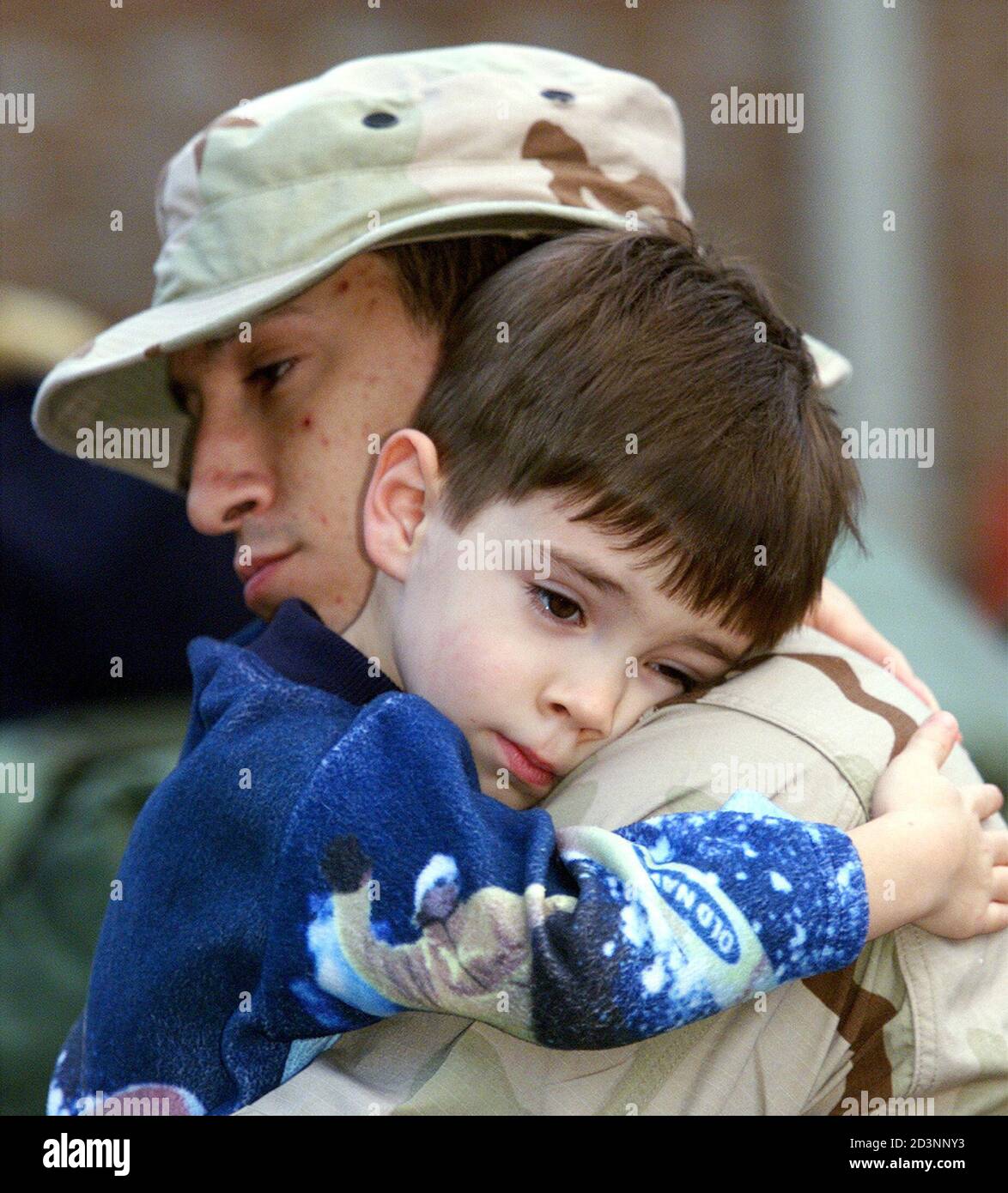 Navy HM-3 Christopher Bryant holds his son Branden, 5-yrs old, at Camp LeJeune, North Carolina before he leaves on a bus for Cherry Point Marine Corps Air Station, North Carolina on January 10, 2003. The United States will soon send 7,000 Marines from Camp Lejeune, North Carolina, to the Gulf to join a major U.S. military build-up in the region for possible war with Iraq, the Marine Corps said on Friday. REUTERS/Randy Davey  RD/MMR Stock Photo