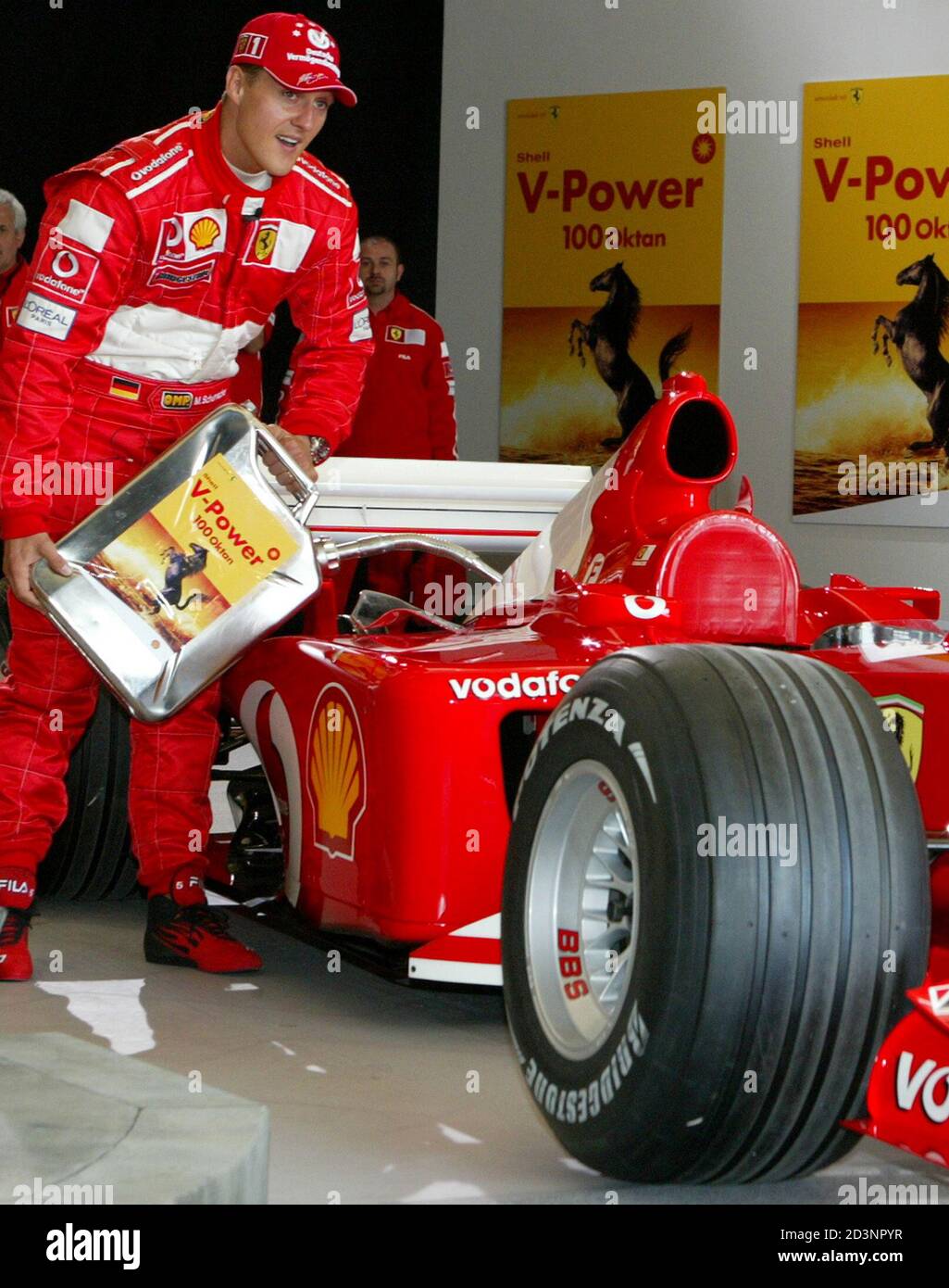 German Formula One Driver Michael Schumacher Poses Beside His Formula One Car During A Presentation Of New Fuel In Berlin April 15 03 Ferrari Sponsor Shell Will Offer The Special Fuel With