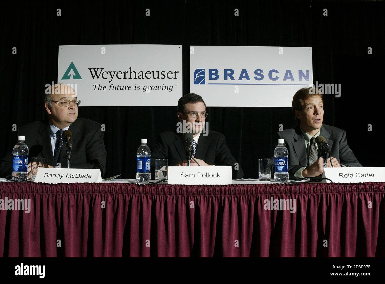 Sandy McDade, President of Weyerhaeuser Company Limited, (L), Sam Pollock, Managing Partner and President of Brascan Investments, (C) and Reid Carter, Managing Partner of Brascan Timberlands Asset Management hold a press conference in Vancouver British Columbia, February 18, 2005. Brascan will purchase Weyerhaeuser's costal assets in Canada for 1.2 billion (CDN), 970 million (USD) plus working capital. REUTERS/Lyle Stafford LS Stock Photo