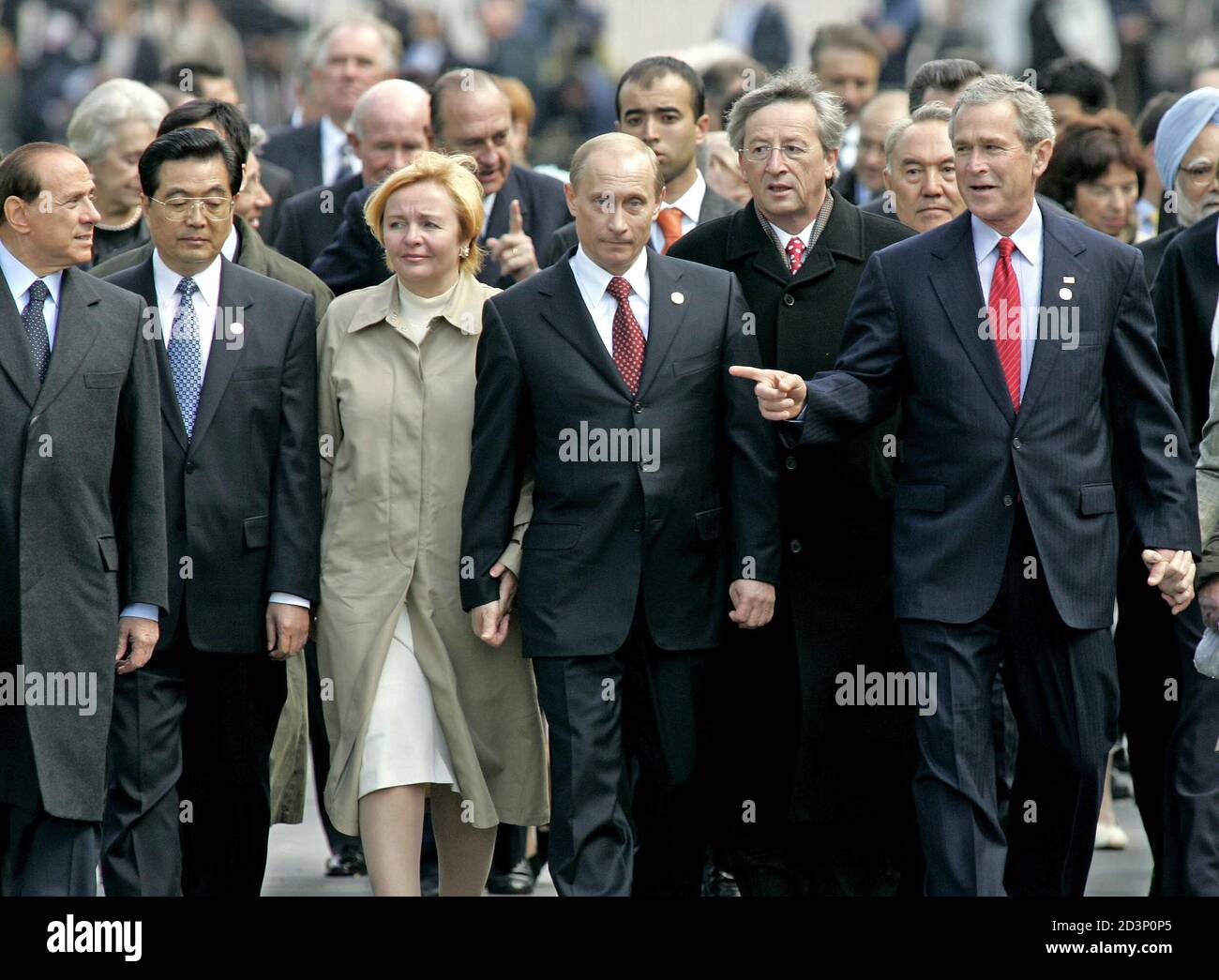 (L to R) Italy's Prime Minister Silvio Berlusconi, Chinese President Hu Jintao, Lyudmila Putin and her husband Russian President Vladimir Putin, European Union President Jean Claude Juncker and U.S. President George W. Bush walk together at the Kremlin in Moscow after attending World War Two commemoration ceremonies in Red Square May 9, 2005. Russia marked World War Two victory with an outpouring of patriotic pride for its huge wartime role and military parades that ignored tensions in relations with its neighbours. Stock Photo