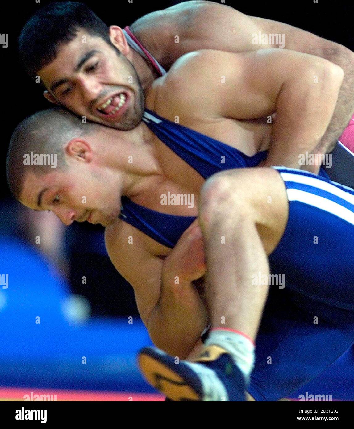 Turkey's Hamza Yerlikaya (top) and Sandor Istvan Bardosi of Hungary compete  in the Greco-Roman 85 kg wrestling class gold medal match at the Olympic  Games in Sydney on September 27, 2000. Yerlikaya