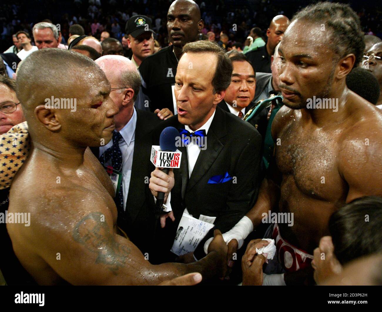 Lennox Lewis (R) and Mike Tyson (L) shake hands as television