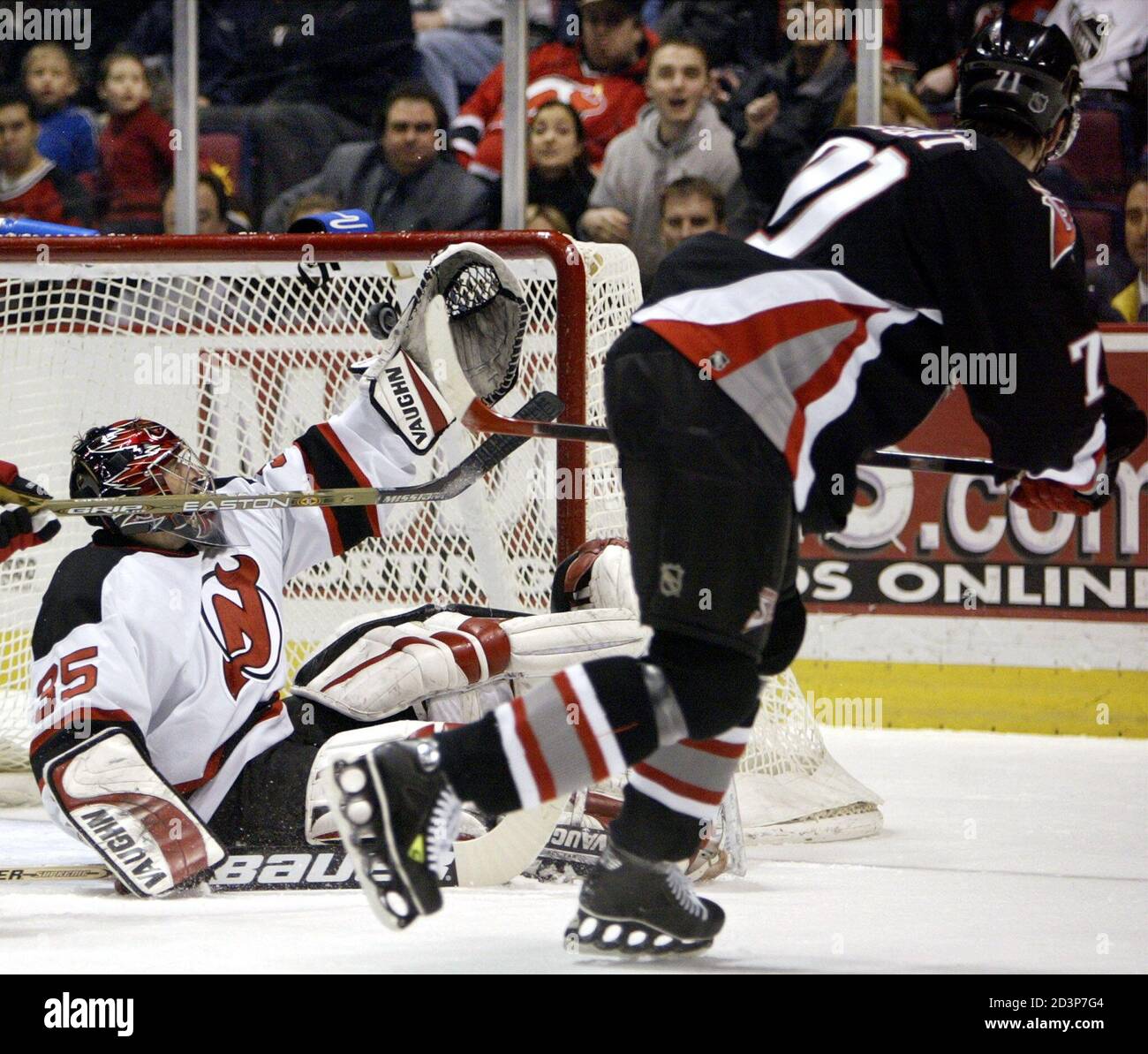 New Jersey Devils goalie Corey Schwab (L) reaches back to deflect a shot by Buffalo  Sabres winger Jochen Hecht at the end of the first period of their NHL game  February 4,