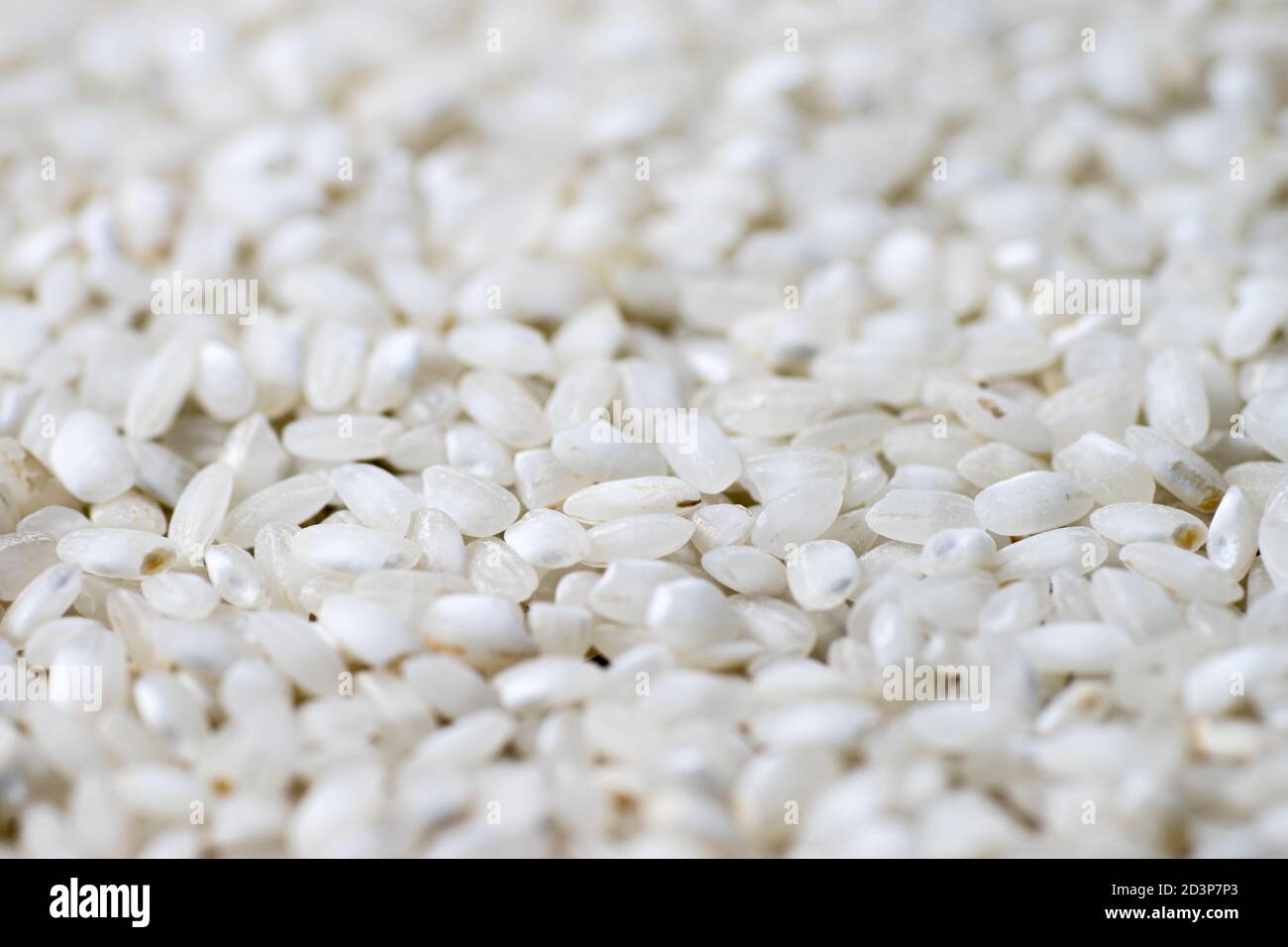 White rice seed texture as background. Perspective Stock Photo